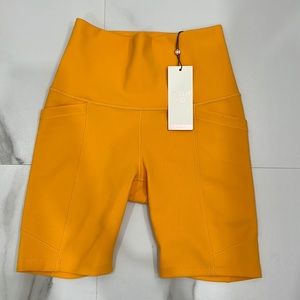 Calia women’s biker short. Size small. Yellow orange color. Come with pockets.